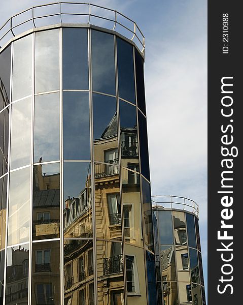 Old Parisian buildings reflected in a modern glass tower. Old Parisian buildings reflected in a modern glass tower