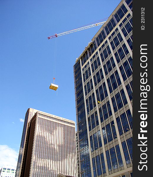 Crane lifting large boxes for construction purposes. Crane lifting large boxes for construction purposes