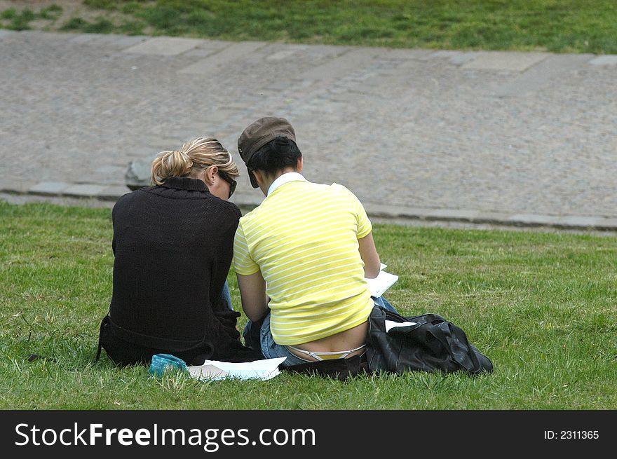 Young girls learning for school in park. Young girls learning for school in park