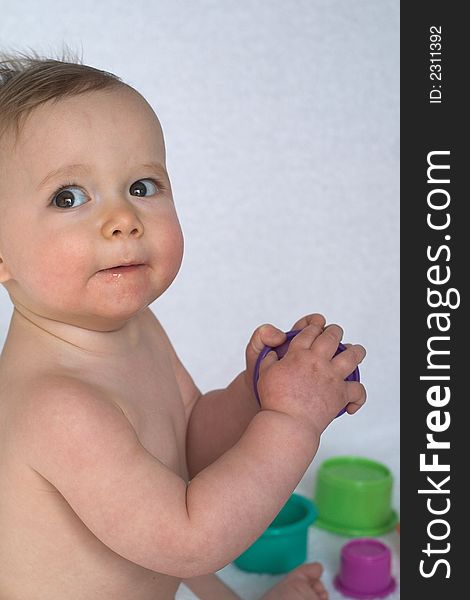 Image of adorable baby playing with stacking cups. Image of adorable baby playing with stacking cups