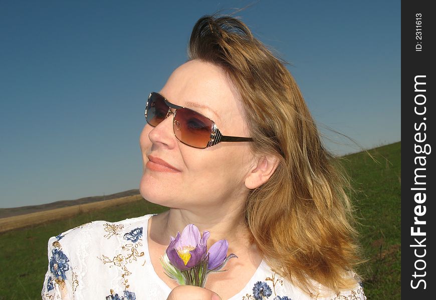 Woman with flowers. Wind rocks the hair