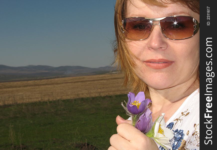 Woman with flowers. Wind rocks the hair