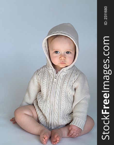 Image of a cute baby wearing a hooded sweater. Image of a cute baby wearing a hooded sweater