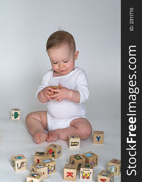 Image of cute baby playing with alphabet blocks. Image of cute baby playing with alphabet blocks