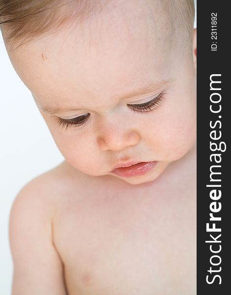 Image of a beautiful baby looking down so his eyelashes are visible. Image of a beautiful baby looking down so his eyelashes are visible