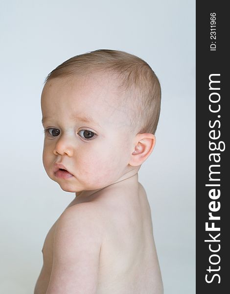 Image of beautiful 11 month old baby boy sitting in front of a white background. Image of beautiful 11 month old baby boy sitting in front of a white background