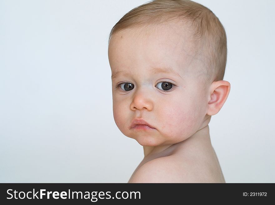 Image of beautiful 11 month old baby boy  sitting in front of a white background. Image of beautiful 11 month old baby boy  sitting in front of a white background