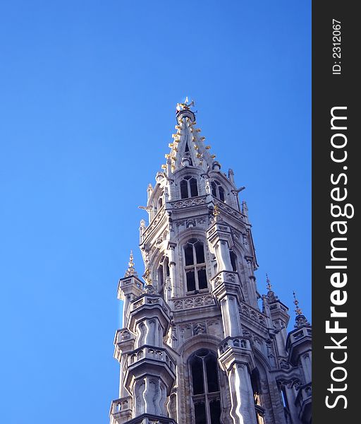 Gothic tower in brussels on the blue sky background