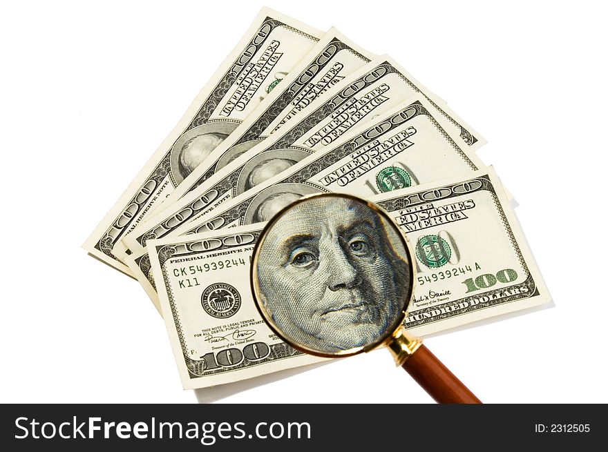 Five hundred dollars isolated over white, magnifier in foreground