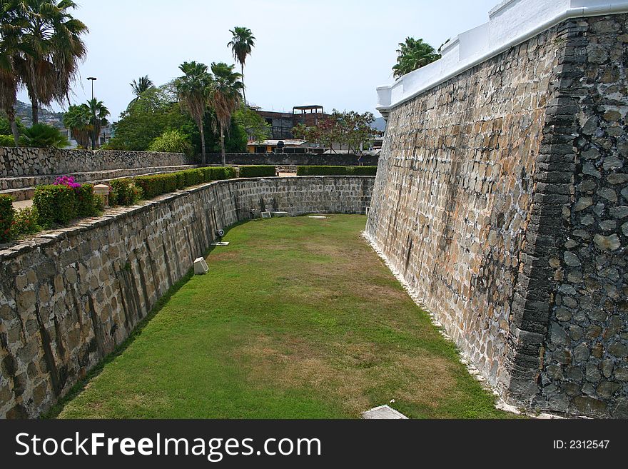 Tall stone wall and defence ditch. Tall stone wall and defence ditch