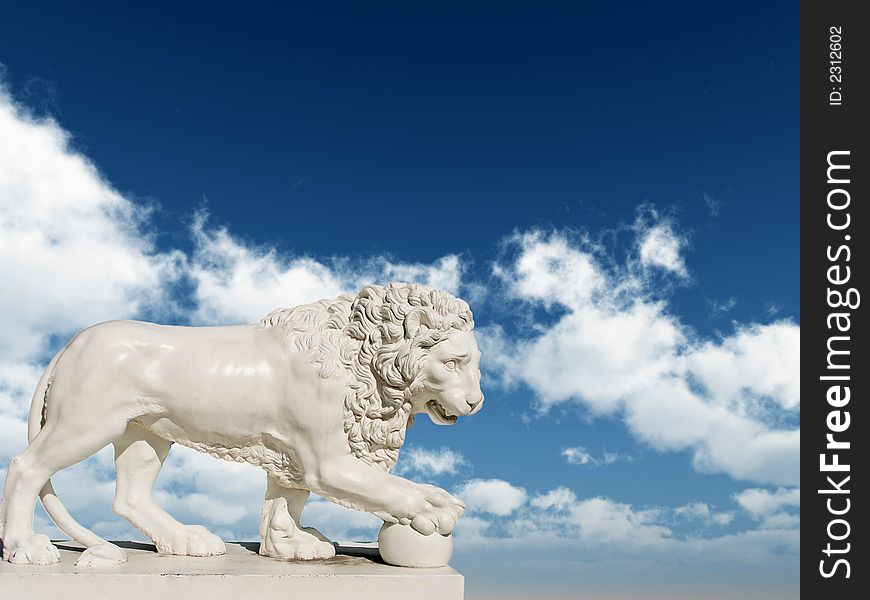 Sculpture of a white lion on a background of the blue sky. Sculpture of a white lion on a background of the blue sky
