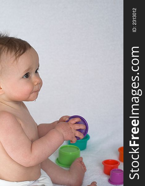 Image of adorable baby playing with stacking cups. Image of adorable baby playing with stacking cups