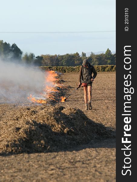 Farm hand lighting part of a Grass/Stubble fire on a paddock in Canterbury, New Zealand. Farm hand lighting part of a Grass/Stubble fire on a paddock in Canterbury, New Zealand.