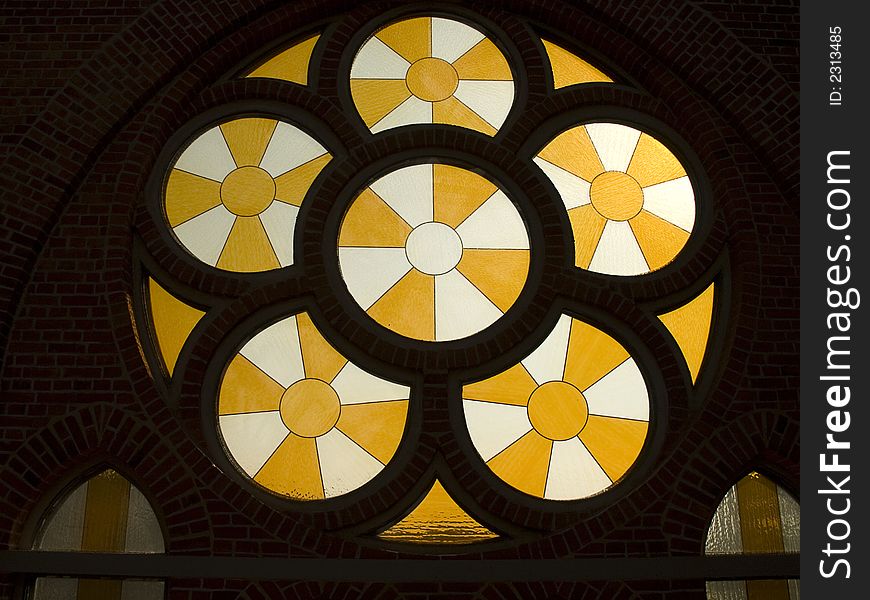 Round church window with yellow and white glass