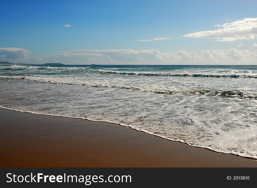 Waves rolling into the shore on a beach in Australia. Waves rolling into the shore on a beach in Australia