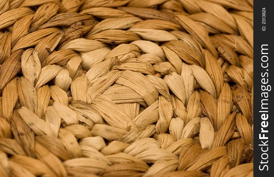 Bottom of a chair made of rattan wickerwork. Close-shot of bottom center. Rattan dry leaves. Bottom of a chair made of rattan wickerwork. Close-shot of bottom center. Rattan dry leaves.