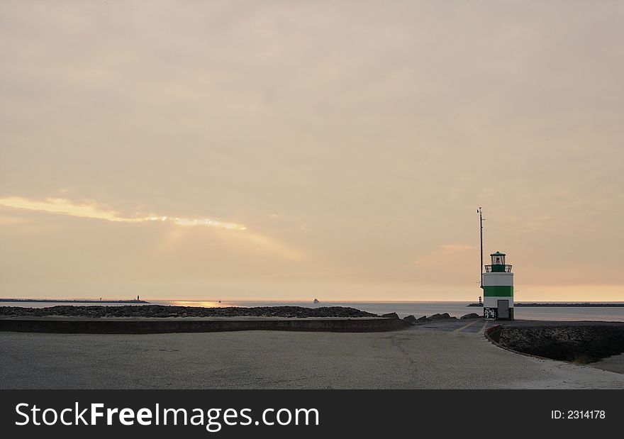 A lightbeacon during sunset at beach. A lightbeacon during sunset at beach