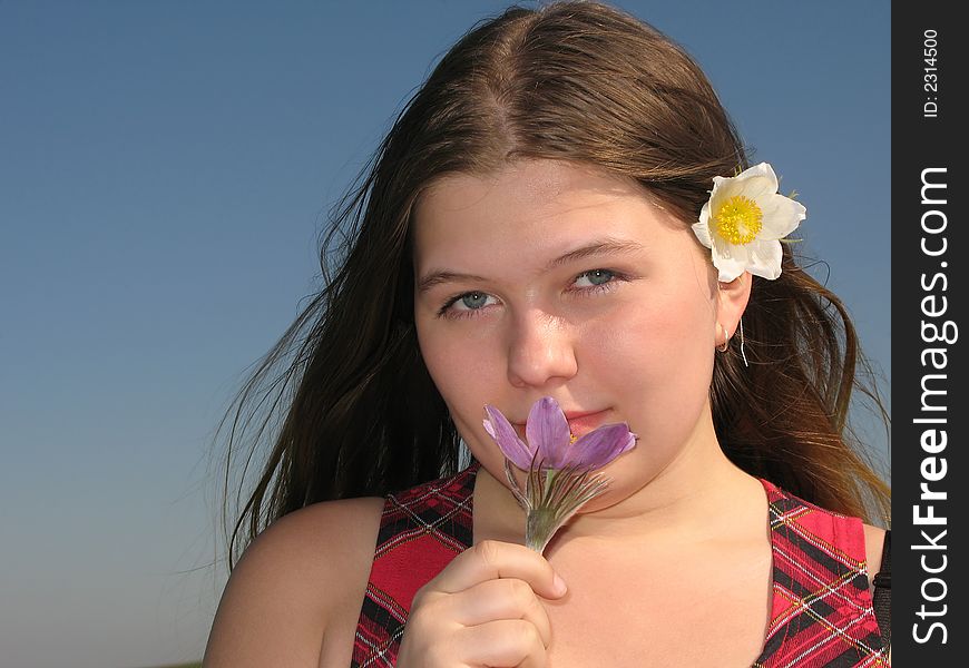 Pretty young girl with the flower in the hair