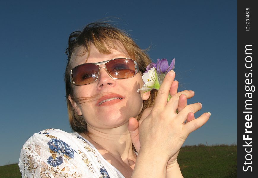 Woman with flowers. Wind rocks the hair