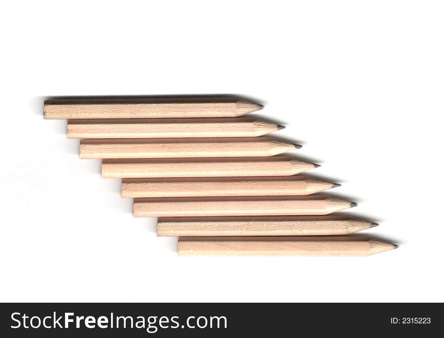 Pencils in a row on an isolated white background. Pencils in a row on an isolated white background
