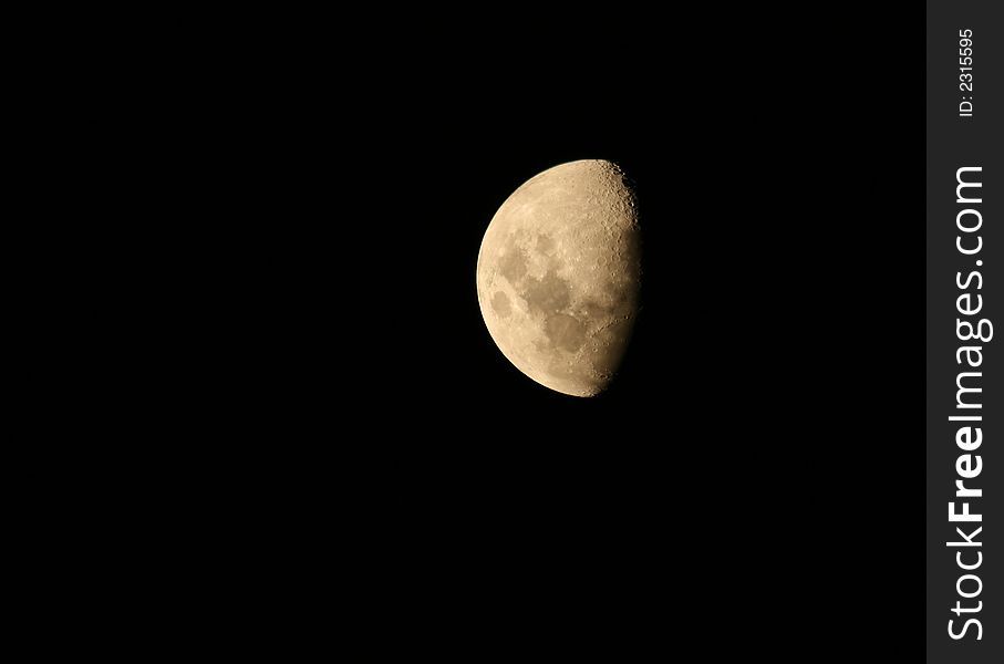 Half moon full of large black craters