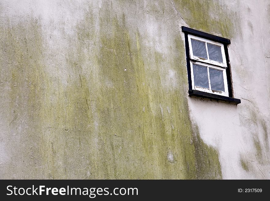 Solitary window with weathered wall