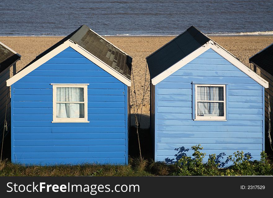 Two blue painted Beach Huts