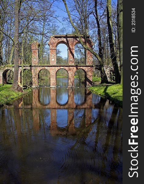 Antique roman aqueduct reflecting in a pool of water. Antique roman aqueduct reflecting in a pool of water