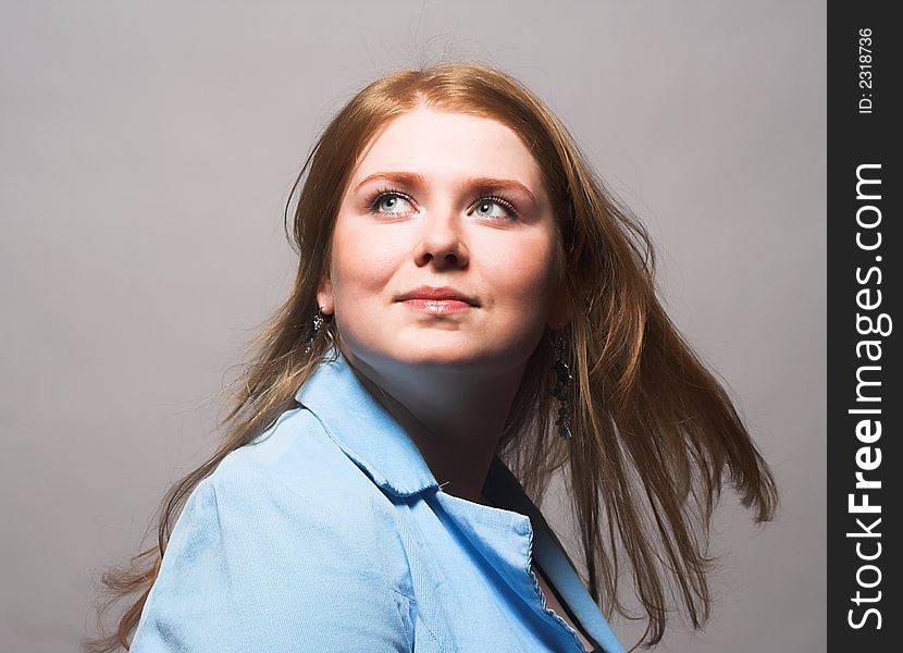 Portrait of Fresh and Beautiful red-hair woman wearing blue shirt. Portrait of Fresh and Beautiful red-hair woman wearing blue shirt