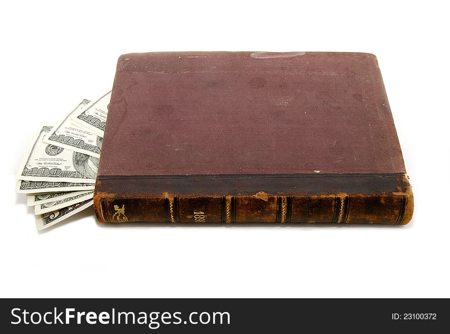 In an old book hidden dollars on white background. In an old book hidden dollars on white background