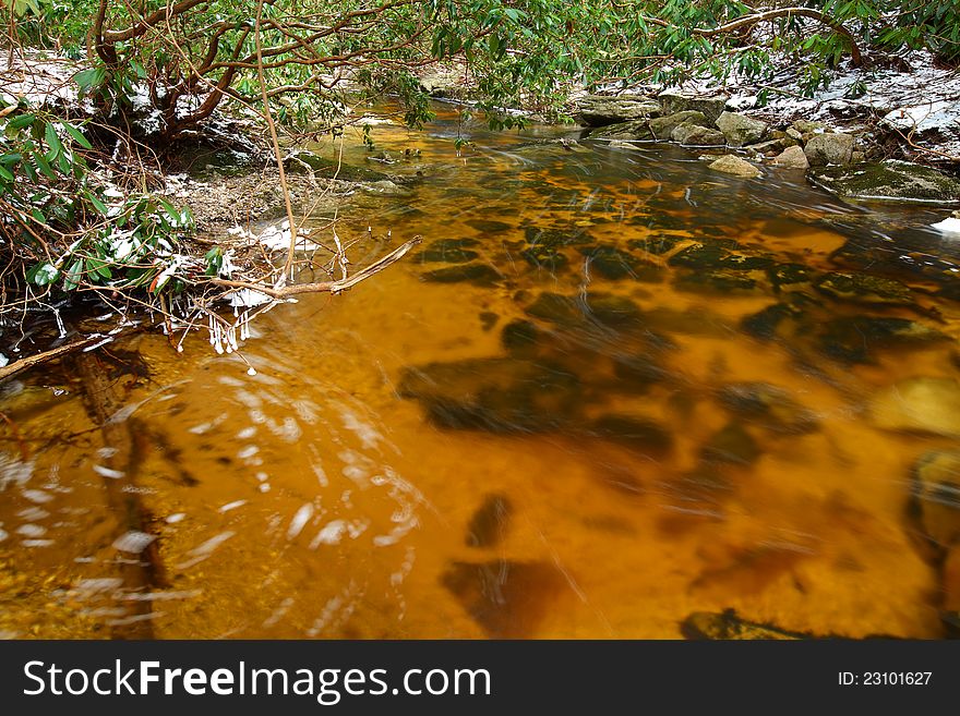 Natural tannin colored stream in the mountains
