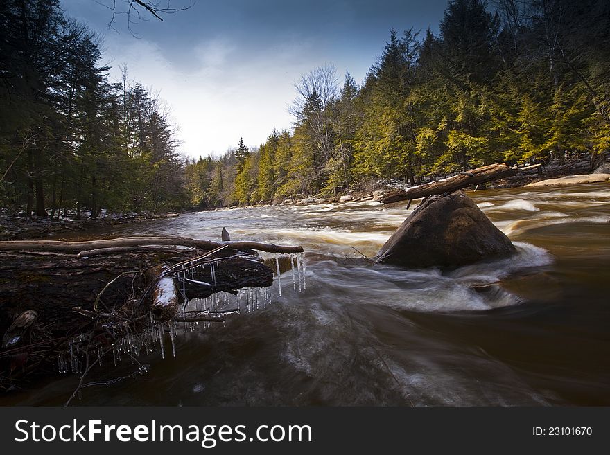 River and rocks in the mountains in winter with silky flow