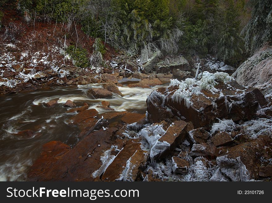 Waterfalls and river in the mountains in winter with silky flow. Waterfalls and river in the mountains in winter with silky flow