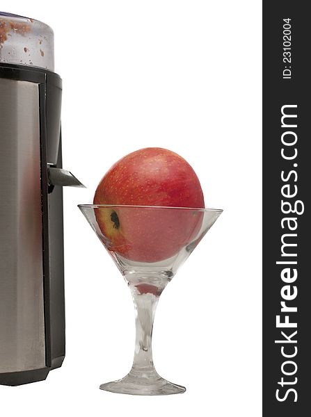 Apple in a glass and a juicer on a white background
