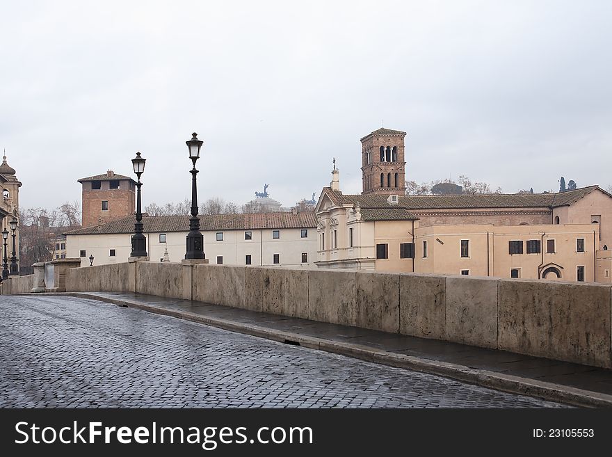 Tranguil urban scene. Old stone bridge with street lamps, Rome, Italy. Tranguil urban scene. Old stone bridge with street lamps, Rome, Italy