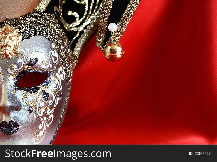 Closeup of classical venetian mask on red silk background with free space for text