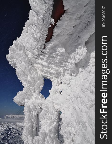 Ice crystals, frozen house at winter in the mountains