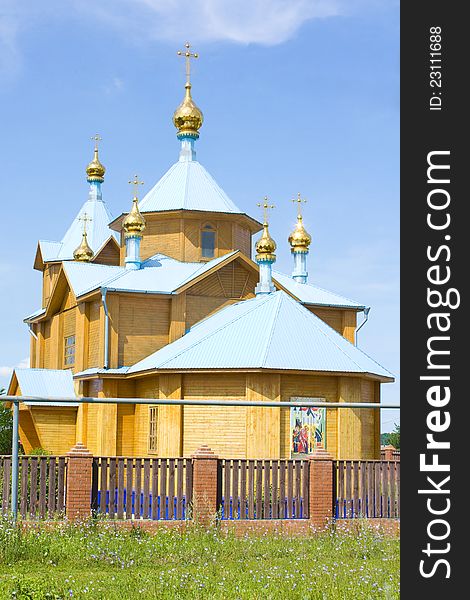 A small rural church in the background of blue sky