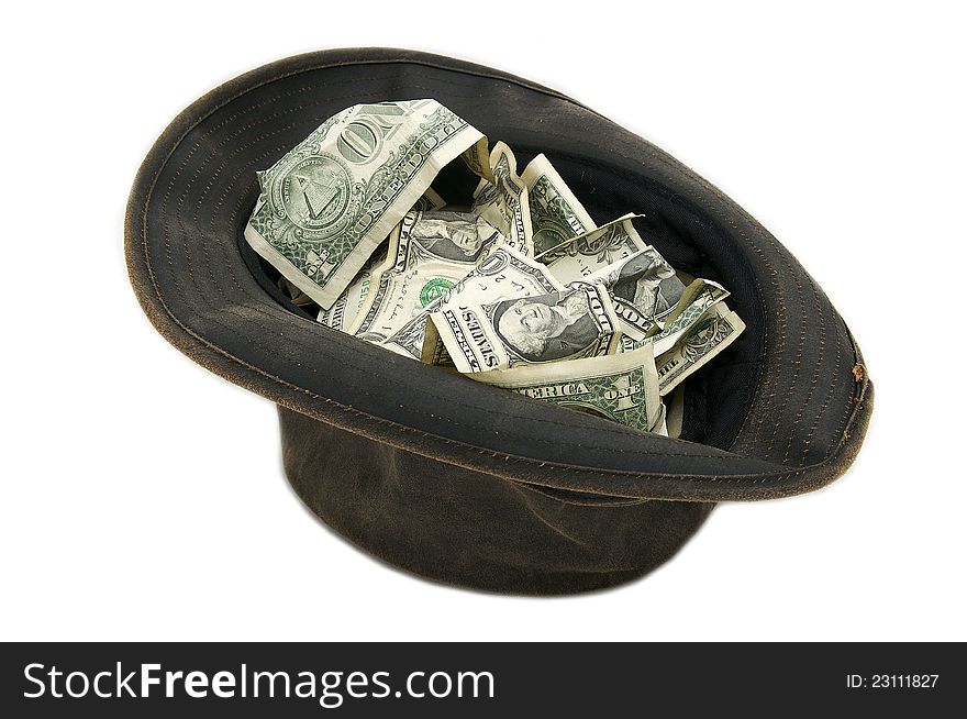 Small notes of dollars in a hat on a white background. Small notes of dollars in a hat on a white background
