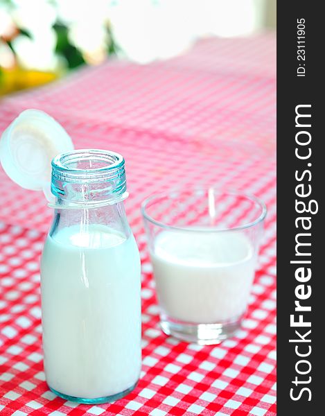 Glass Of Milk And Bottle On Table