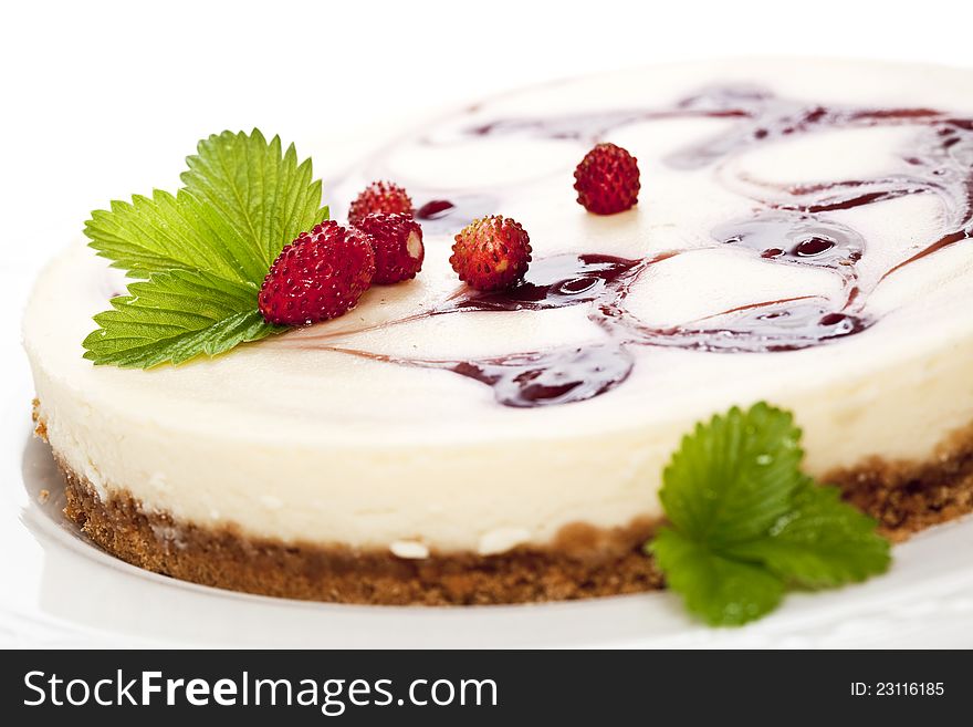 Cheese cake with wild strawberries. Close up.