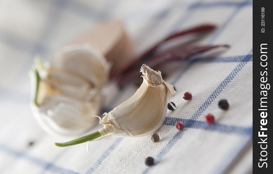 Garlic with pepper on textile background