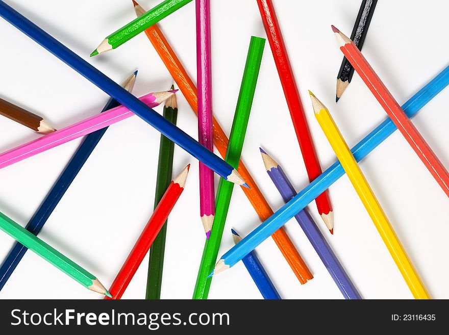 Set of colourful pencils spread on white background