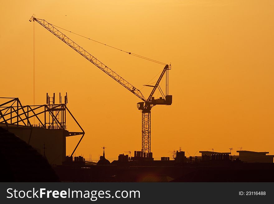 Crane on a sunset background. Building site