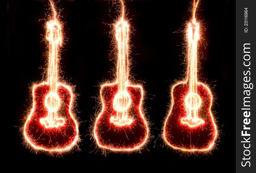 Sparkling guitarr silhouette against a black background. Sparkling guitarr silhouette against a black background