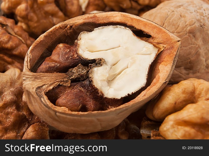 Cracked open walnut on a walnut pile