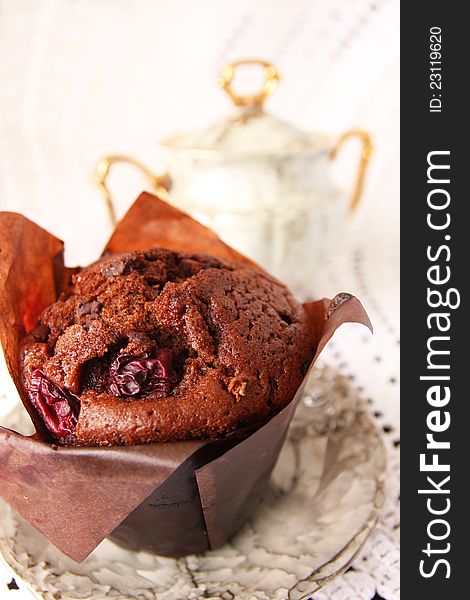 Delicious chocolate muffin in a porcelain saucer