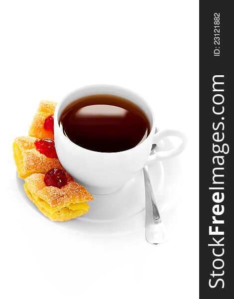 White cup of tea on a saucer and cake and jam on white background