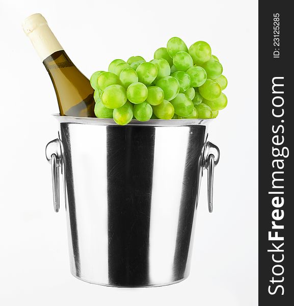 White wine bottle in cold ice bucket on white