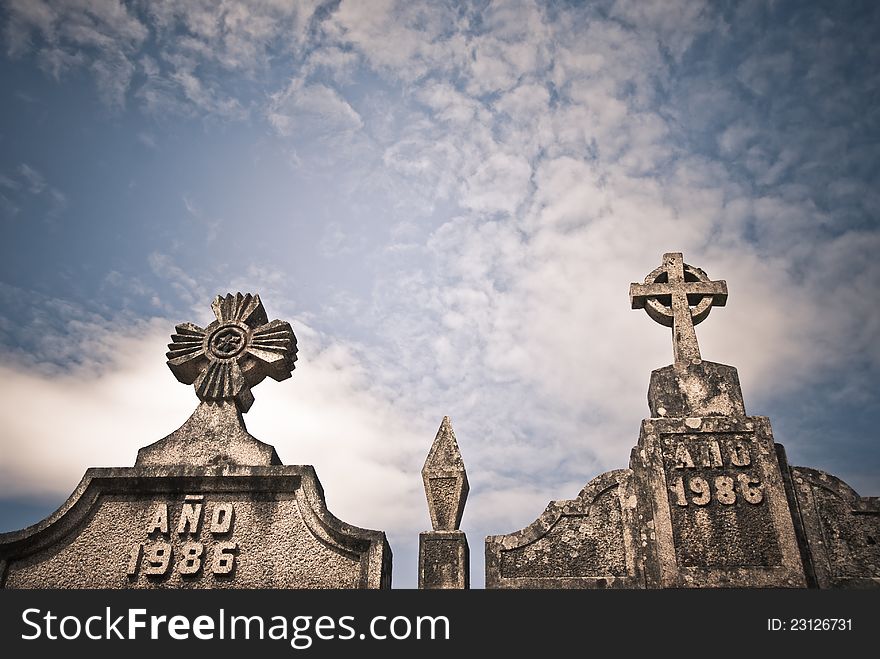 Stone crosses in a Catholic cemetery and sky with clouds. Stone crosses in a Catholic cemetery and sky with clouds